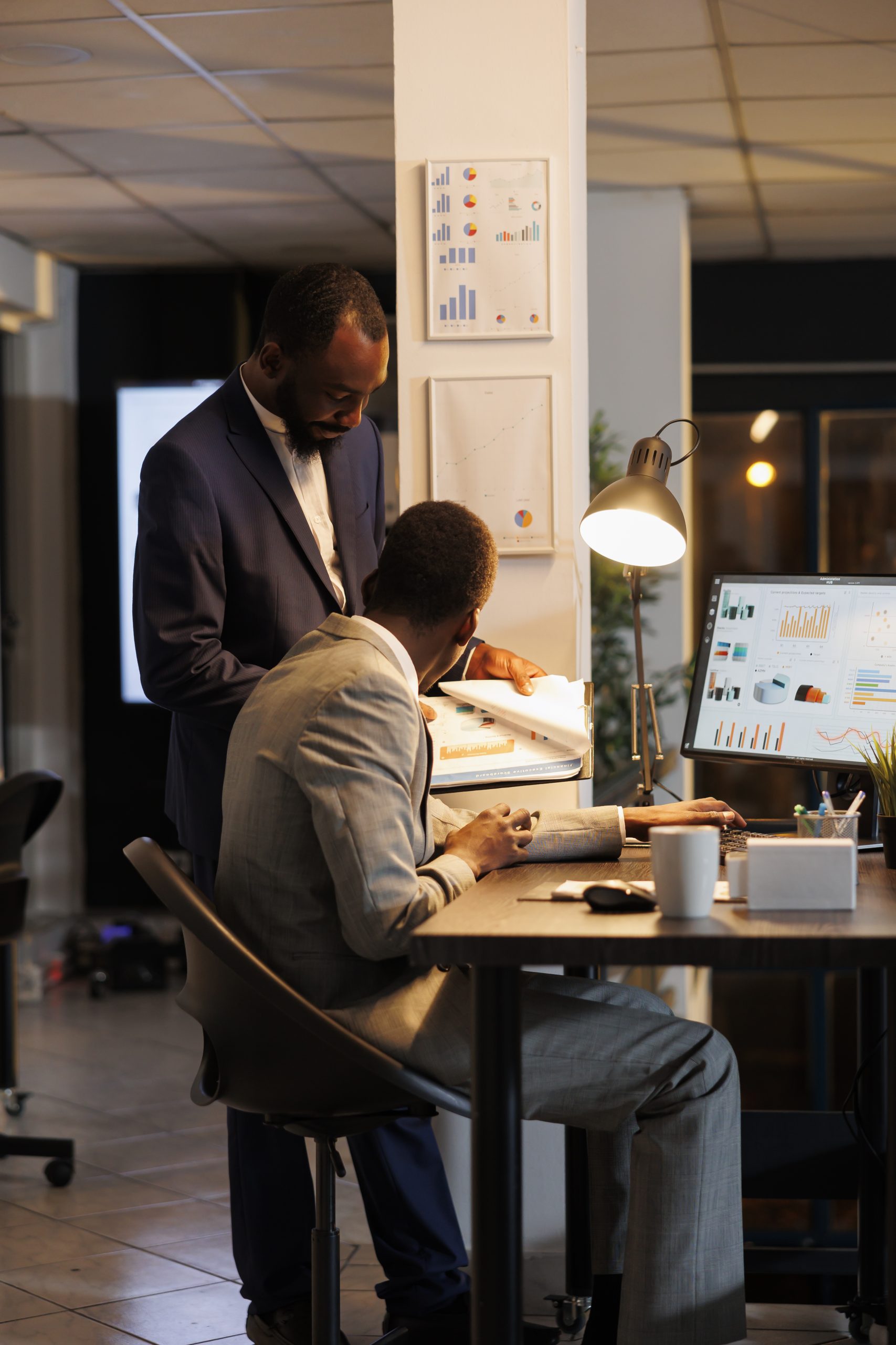 employees looking financial statistics computer scaled
